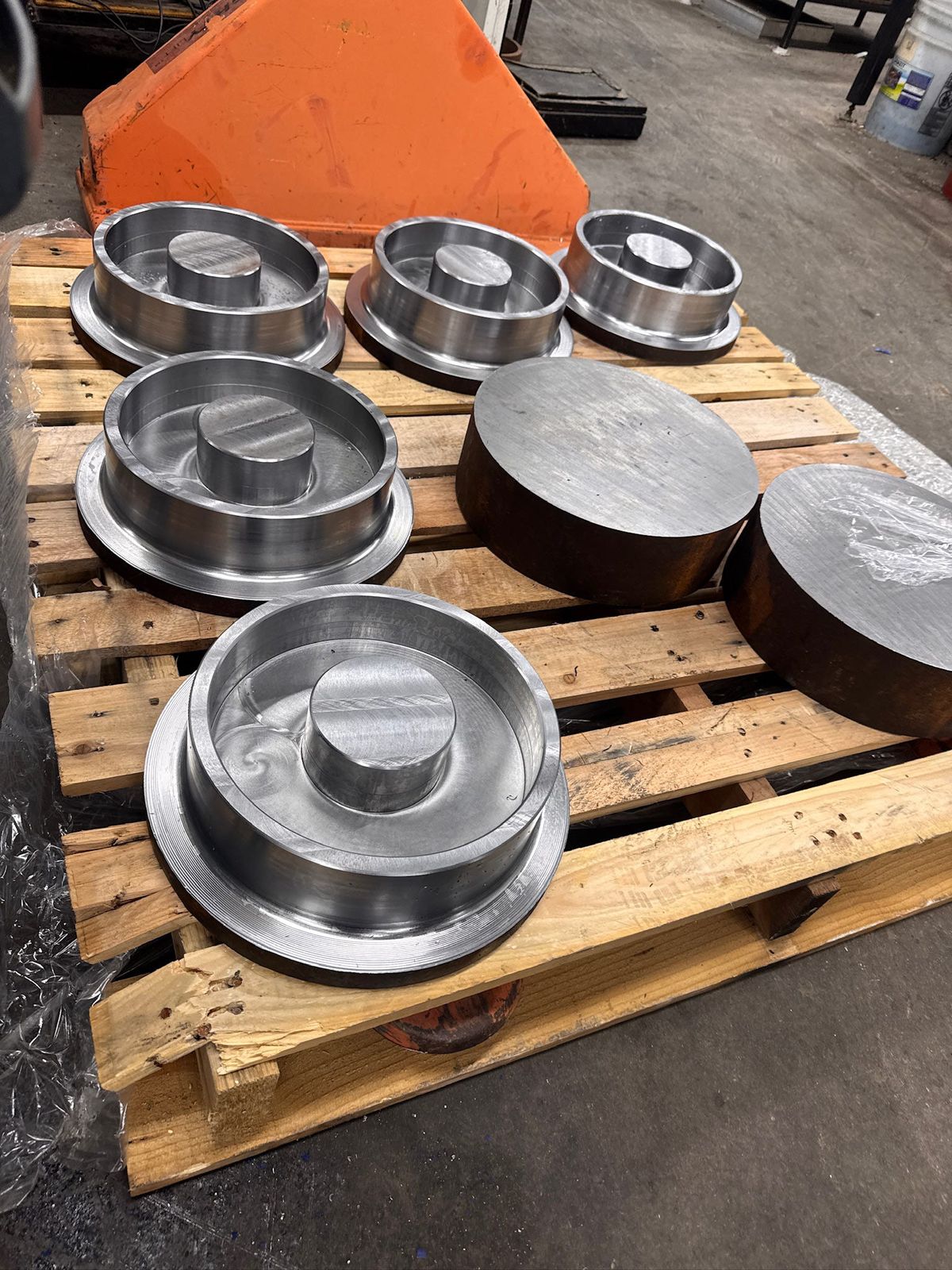 Large turned parts and round stock on a pallet