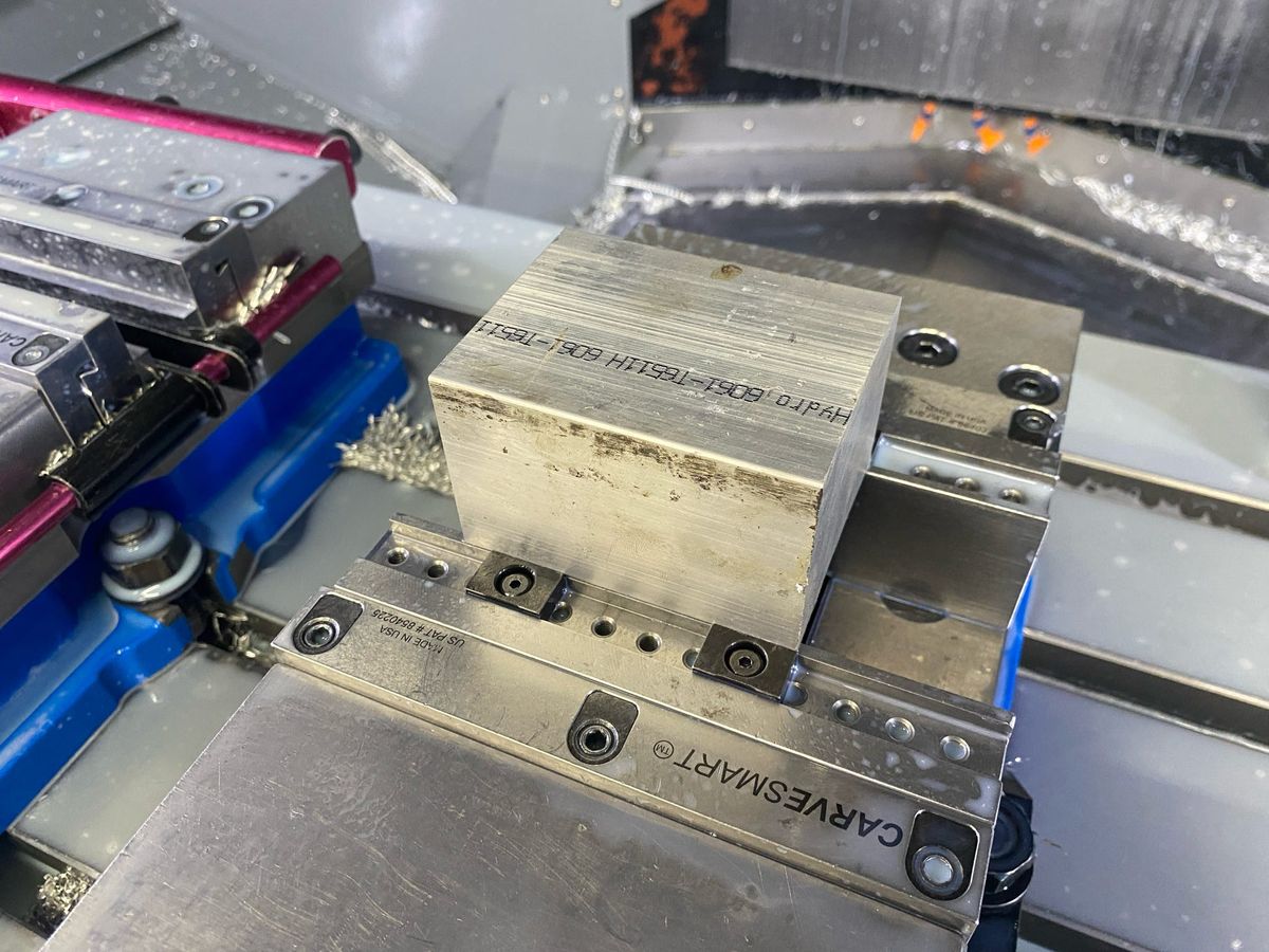 Part held in a vise inside the machine