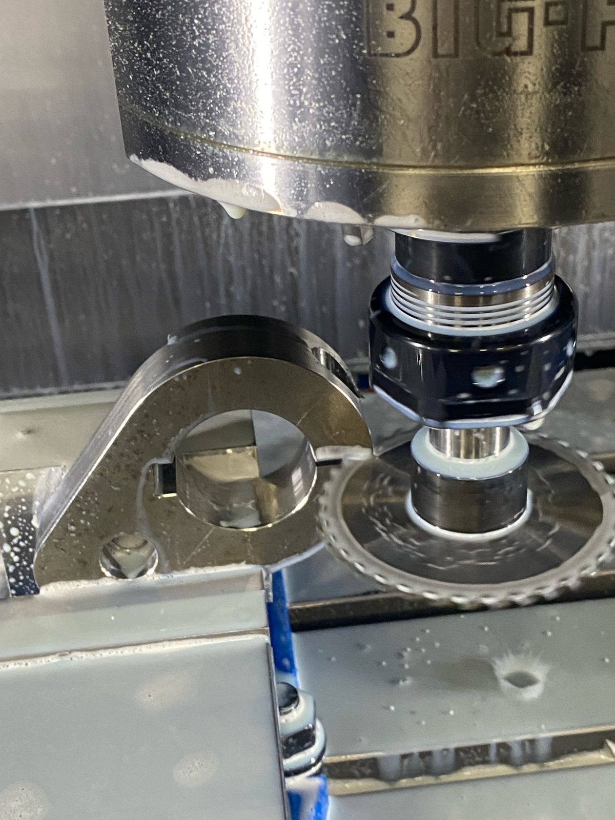 Spindle running a slitting saw through a clamp part
