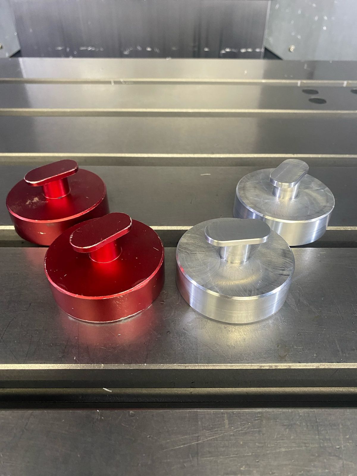 Red anodized and bare aluminum caps