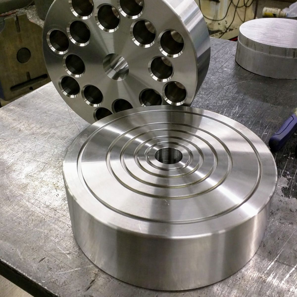 Large faced round part with a bored plate behind it